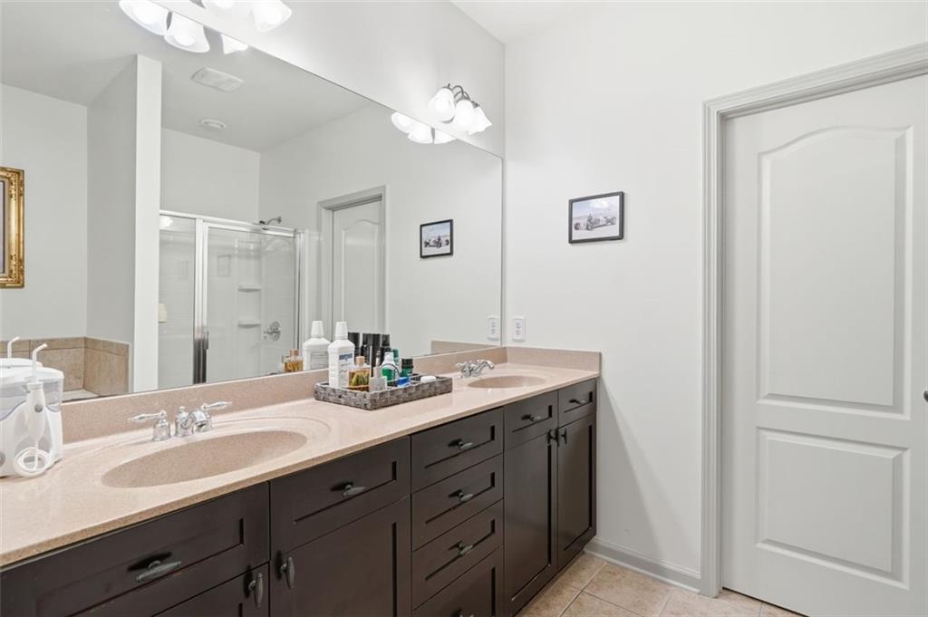 1114 Firethorne Pass Cumming, GA 30040 - Photo 19 of 43 a bathroom with a double vanity sink and a mirror