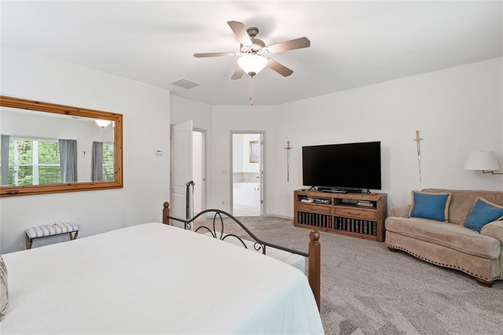 1114 Firethorne Pass Cumming, GA 30040 - Photo 22 of 43 a bedroom with bed and a flat screen tv
