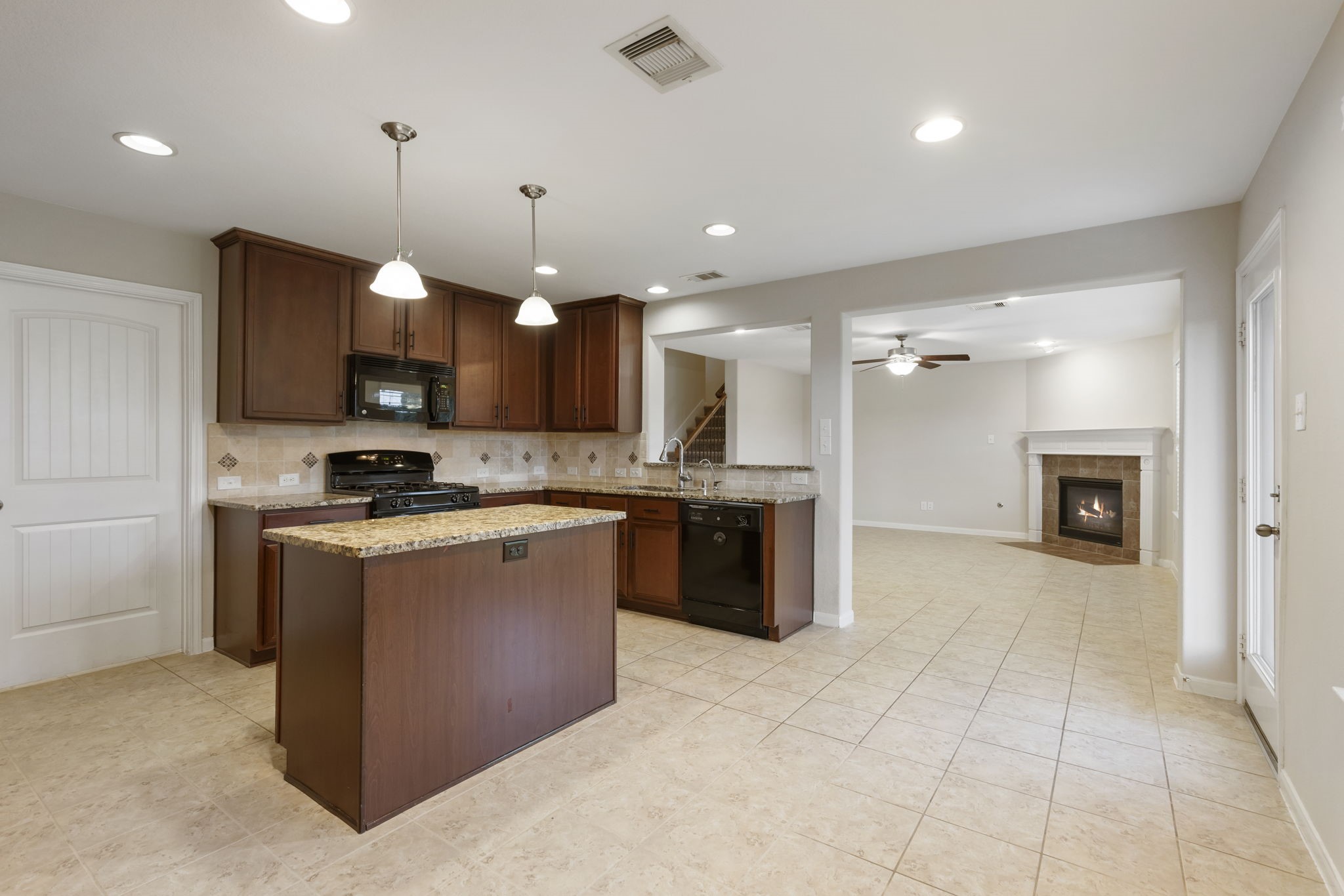 7130 Edwanna Lane Spring, TX 77389 - Photo 9 of 36 The Chef of the home will love the open-concept kitchen with tons of cabinets, granite countertops, a central island, and modern appliances.