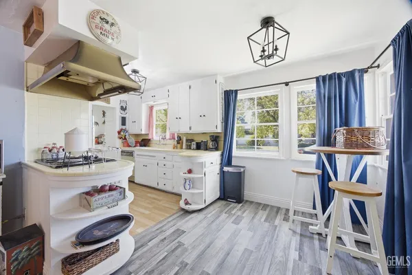 a kitchen with sink cabinets and wooden floor