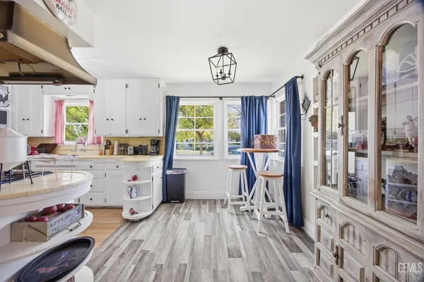 a kitchen with a sink a refrigerator and cabinets