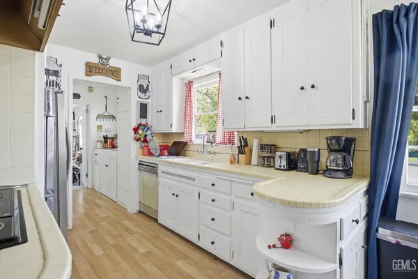 a kitchen with stainless steel appliances granite countertop a sink and cabinets