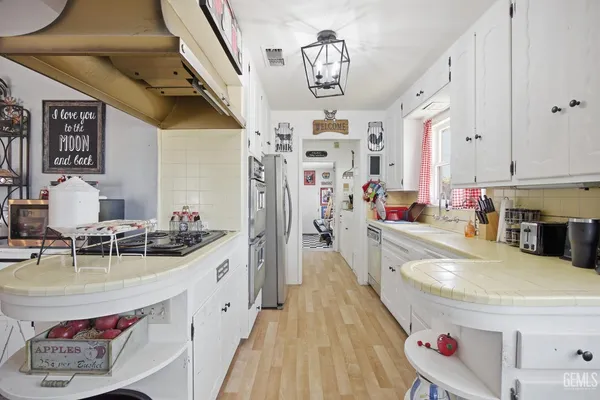 a kitchen with stainless steel appliances kitchen island granite countertop a sink and cabinets