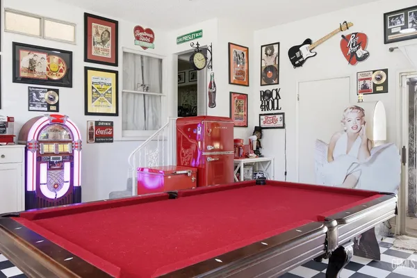 a view of a livingroom with furniture and a hallway