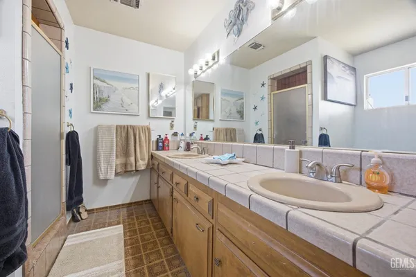 a bedroom with a bed and a flat tv screen on the wall