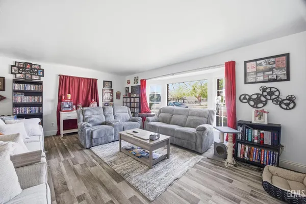 a living room with furniture and a book shelf