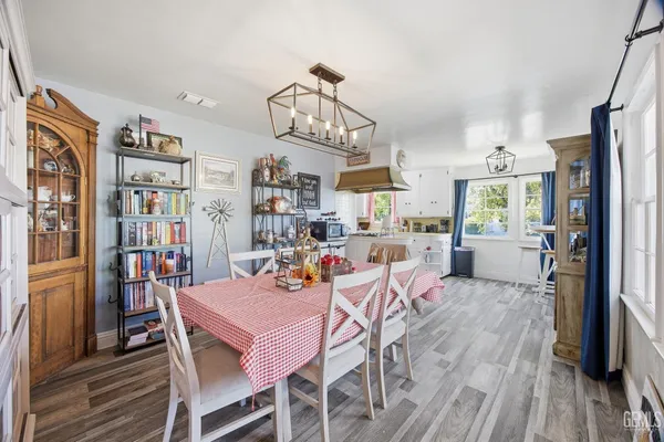 a view of a dining room with furniture window and wooden floor