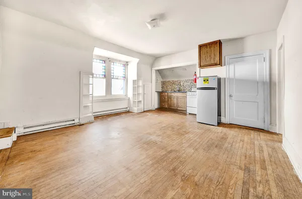 a view of a kitchen with refrigerator and microwave