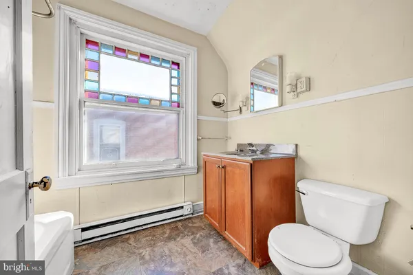 a white toilet sitting next to a bathroom sink and tub