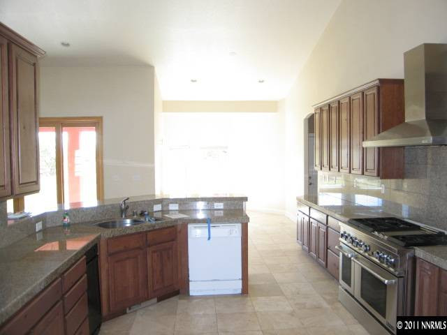 4805 Rancheria Road Fallon, NV 89406 - Photo 7 of 13 a kitchen with stainless steel appliances granite countertop a stove a sink and a microwave