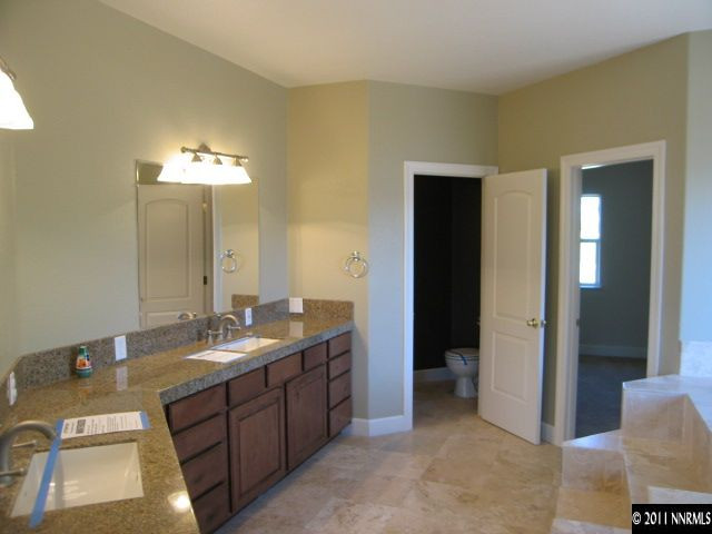 4805 Rancheria Road Fallon, NV 89406 - Photo 10 of 13 a spacious bathroom with a double vanity sink and a mirror