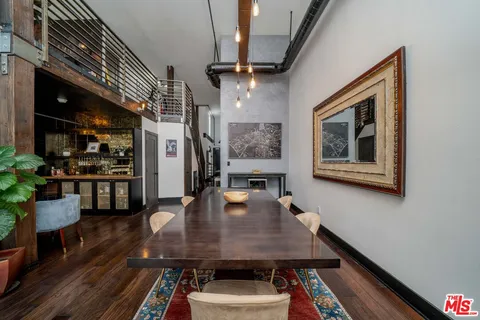 a dining room with furniture and wooden floor
