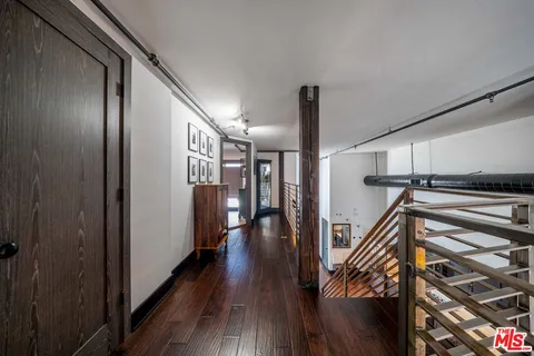 a view of hallway with wooden floor