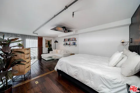 a bedroom with a bed window and couch