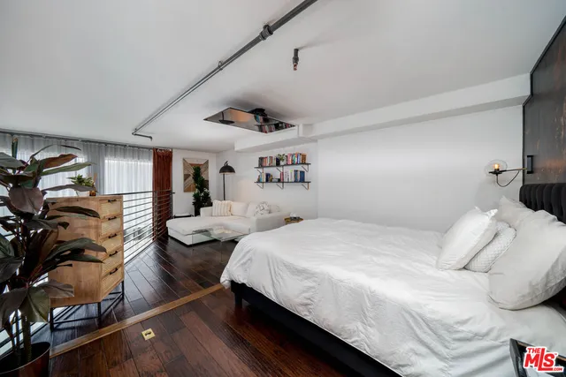 a bedroom with a bed window and couch