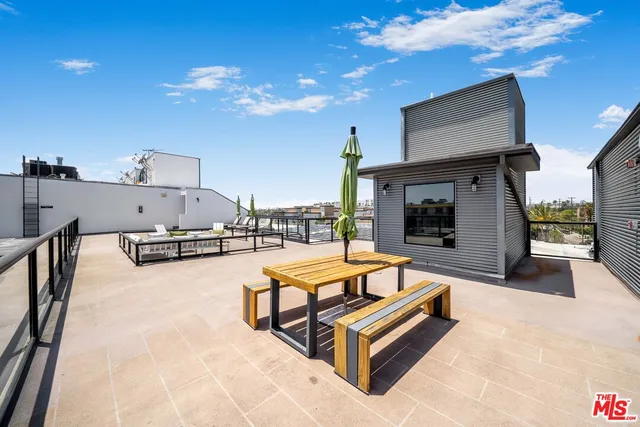 a outdoor space with the couches and a fireplace