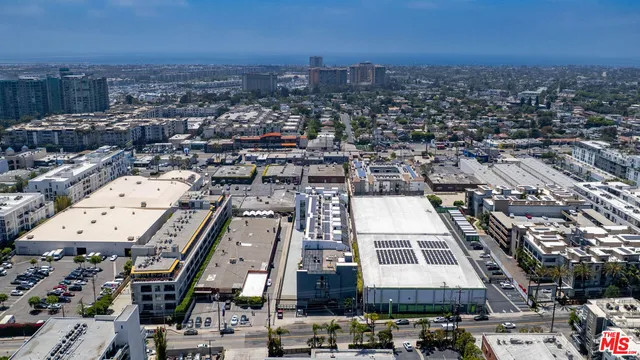 an aerial view of a building with streets and trees