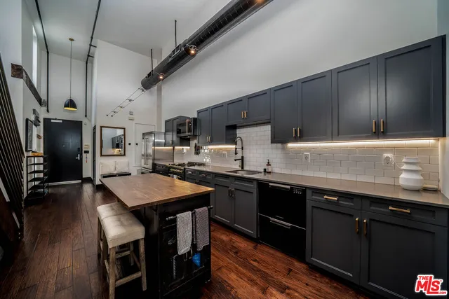 a kitchen with granite countertop a sink appliances and cabinets