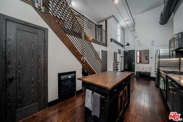 a open kitchen with a table chairs and a refrigerator