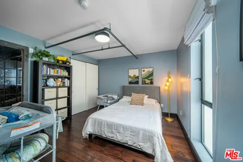 a bedroom with a bed and a book shelf