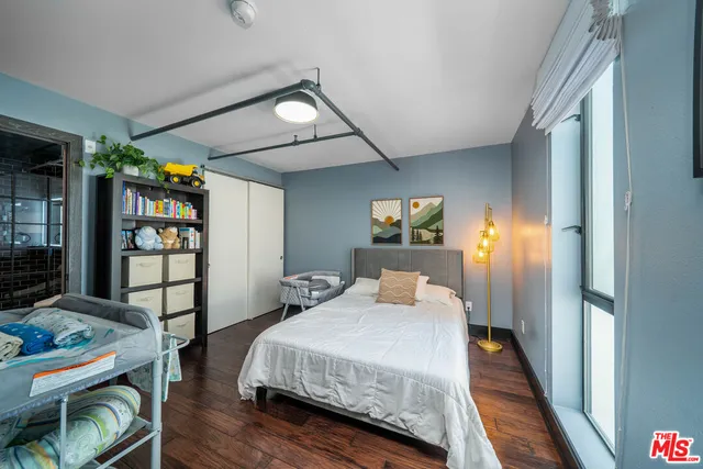 a bedroom with a bed and a book shelf