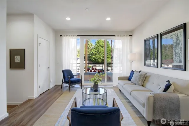 a living room with furniture and a large window