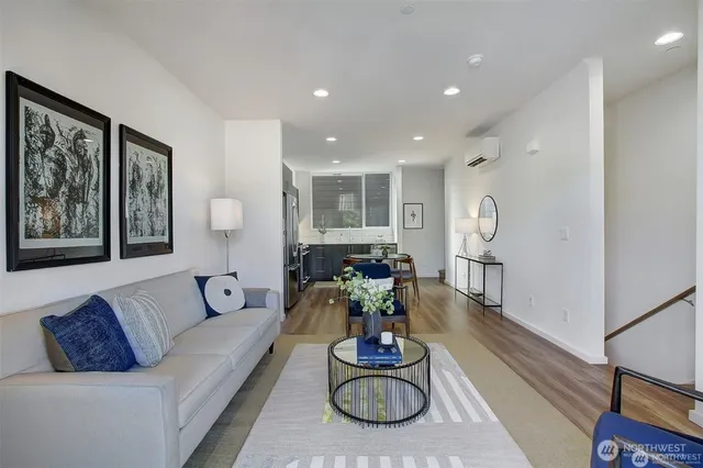 a living room with furniture and a hard wood floor