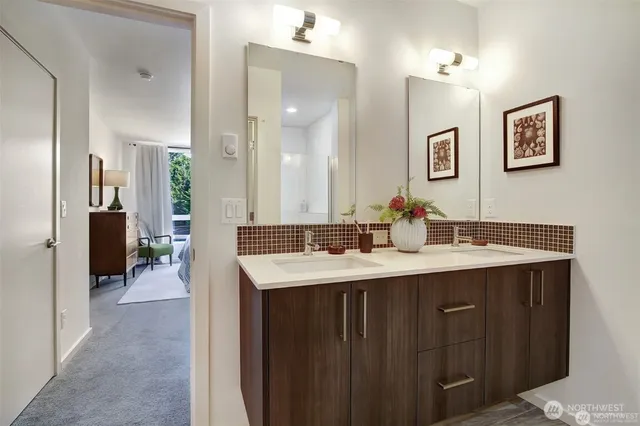a bathroom with a sink double vanity and a mirror