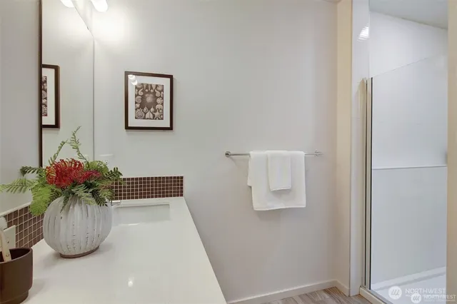 a white vase with flowers sitting on a table