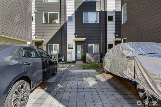 a view of a house with a barbeque and wooden stairs