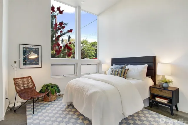 a bedroom with a bed and a chair