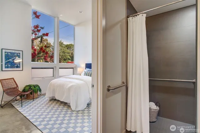 a bedroom with a bed and a window