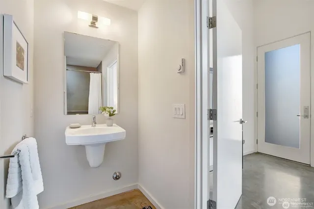 a bathroom with a sink a toilet and mirror