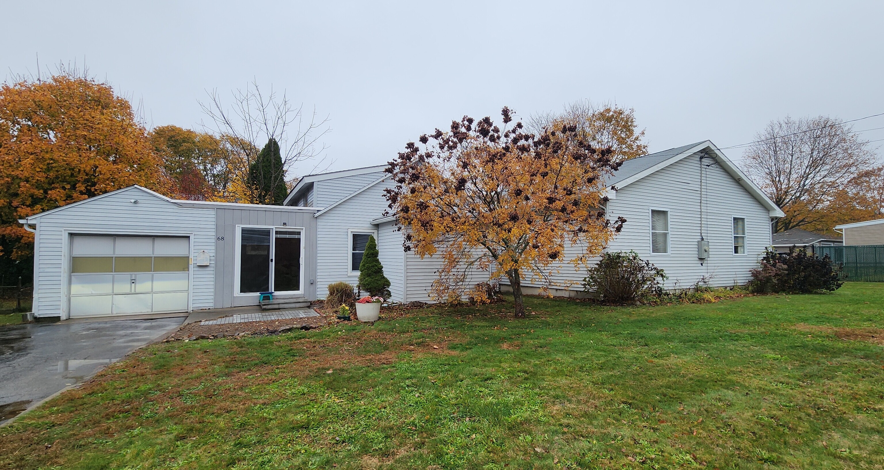 68 Clark Lane Waterford, CT 06385 - Photo 1 of 28 a front view of a house with a yard and garage