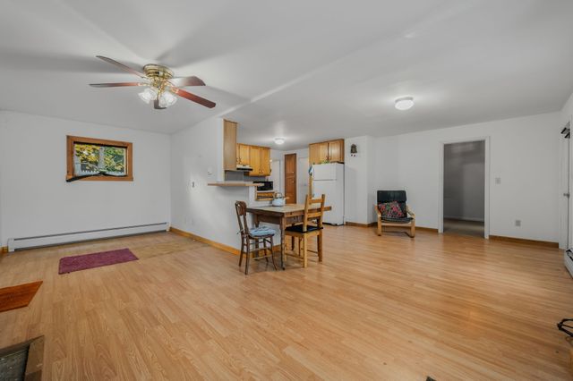 a view of a livingroom with furniture and a table chairs