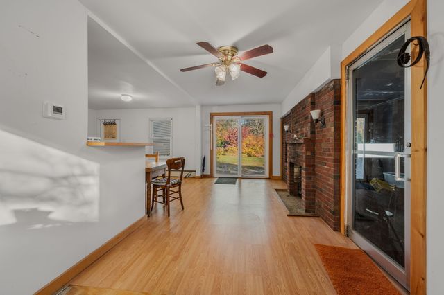 a view of a livingroom with furniture hardwood floor and a ceiling fan