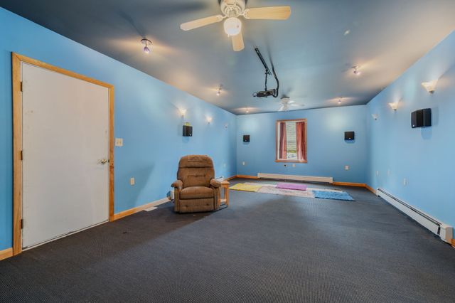 a room with pool table and windows