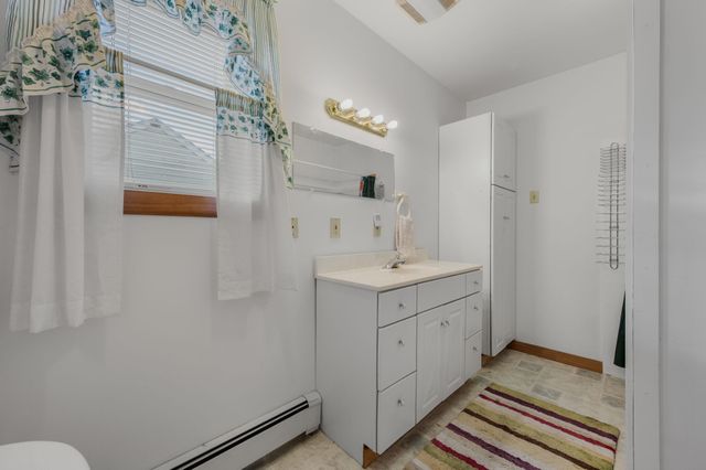 a spacious bathroom with a double vanity sink a and mirror