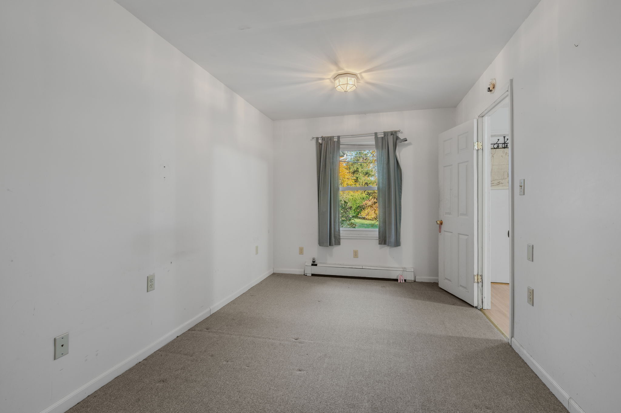 68 Clark Lane Waterford, CT 06385 - Photo 23 of 28 an empty room with a window and wooden floor