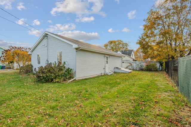 a view of backyard of house and green space