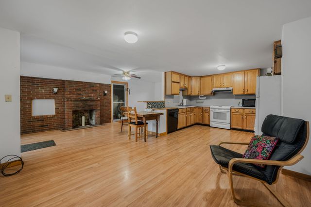 a living room with furniture and kitchen view