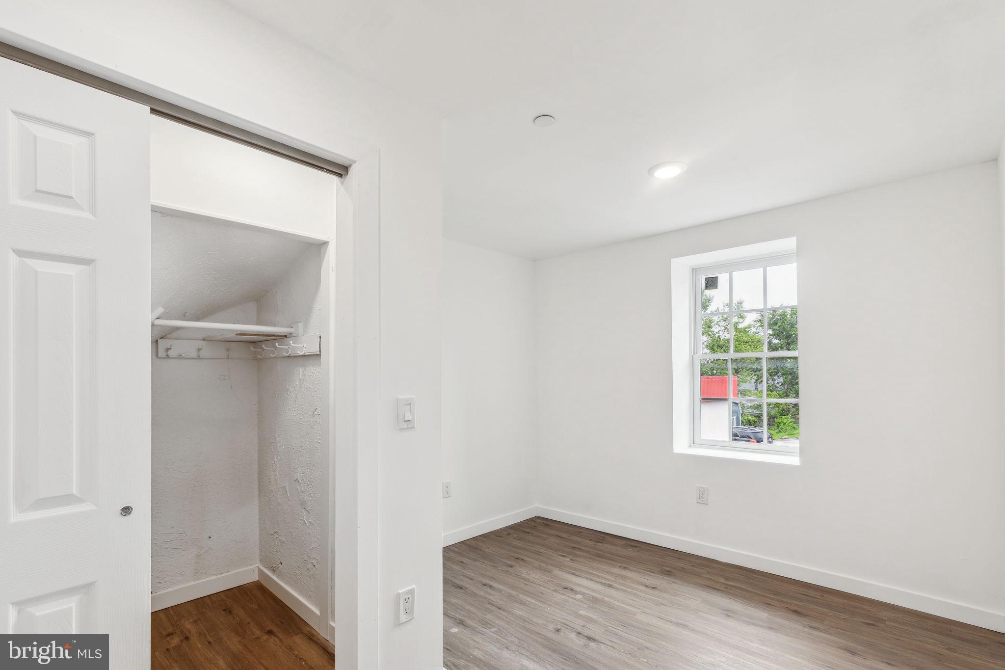 7041 Ridge Avenue Philadelphia, PA 19128 - Photo 14 of 22 an empty room with wooden floor and a window