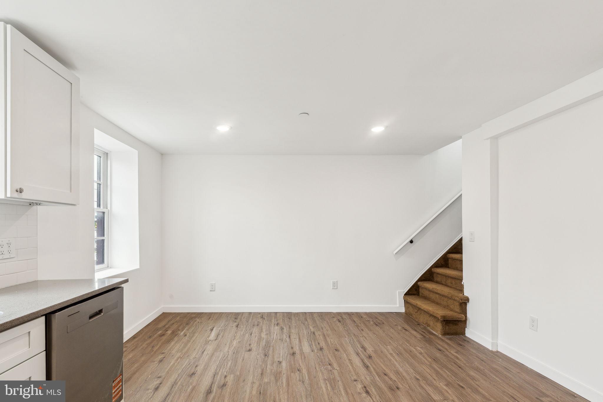 7041 Ridge Avenue Philadelphia, PA 19128 - Photo 19 of 22 a view of an empty room with wooden floor and stairs
