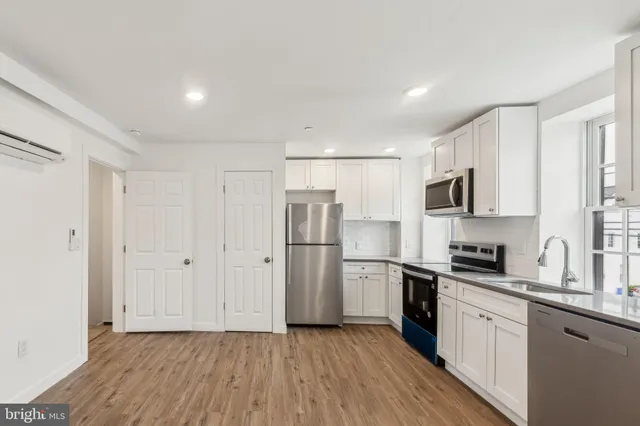 a kitchen with stainless steel appliances a refrigerator sink and microwave