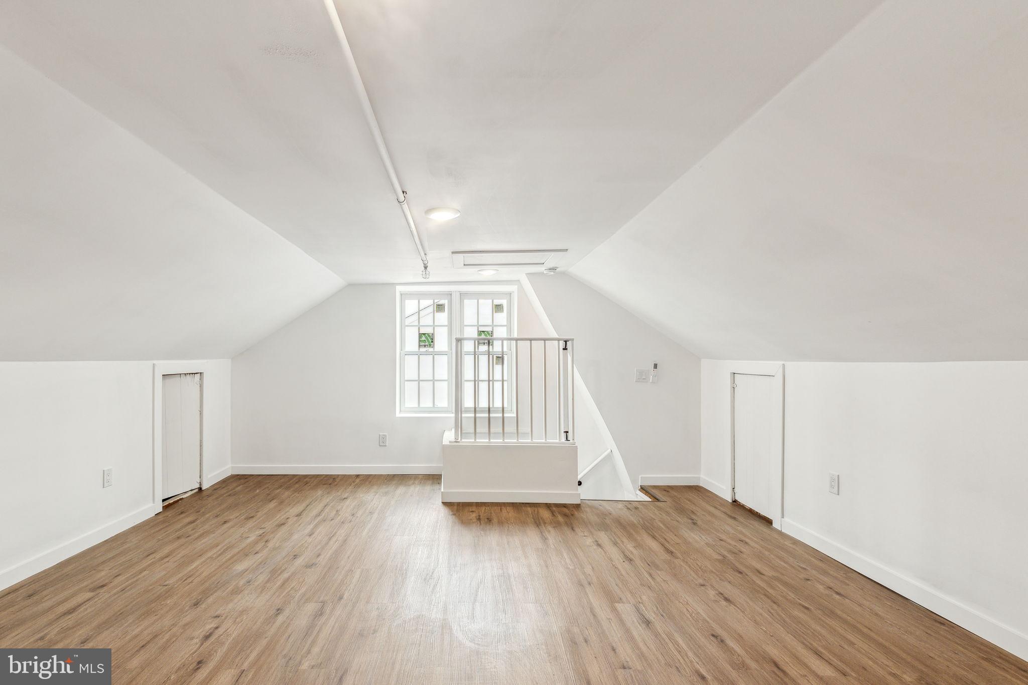 7041 Ridge Avenue Philadelphia, PA 19128 - Photo 7 of 22 an empty room with wooden floor and windows