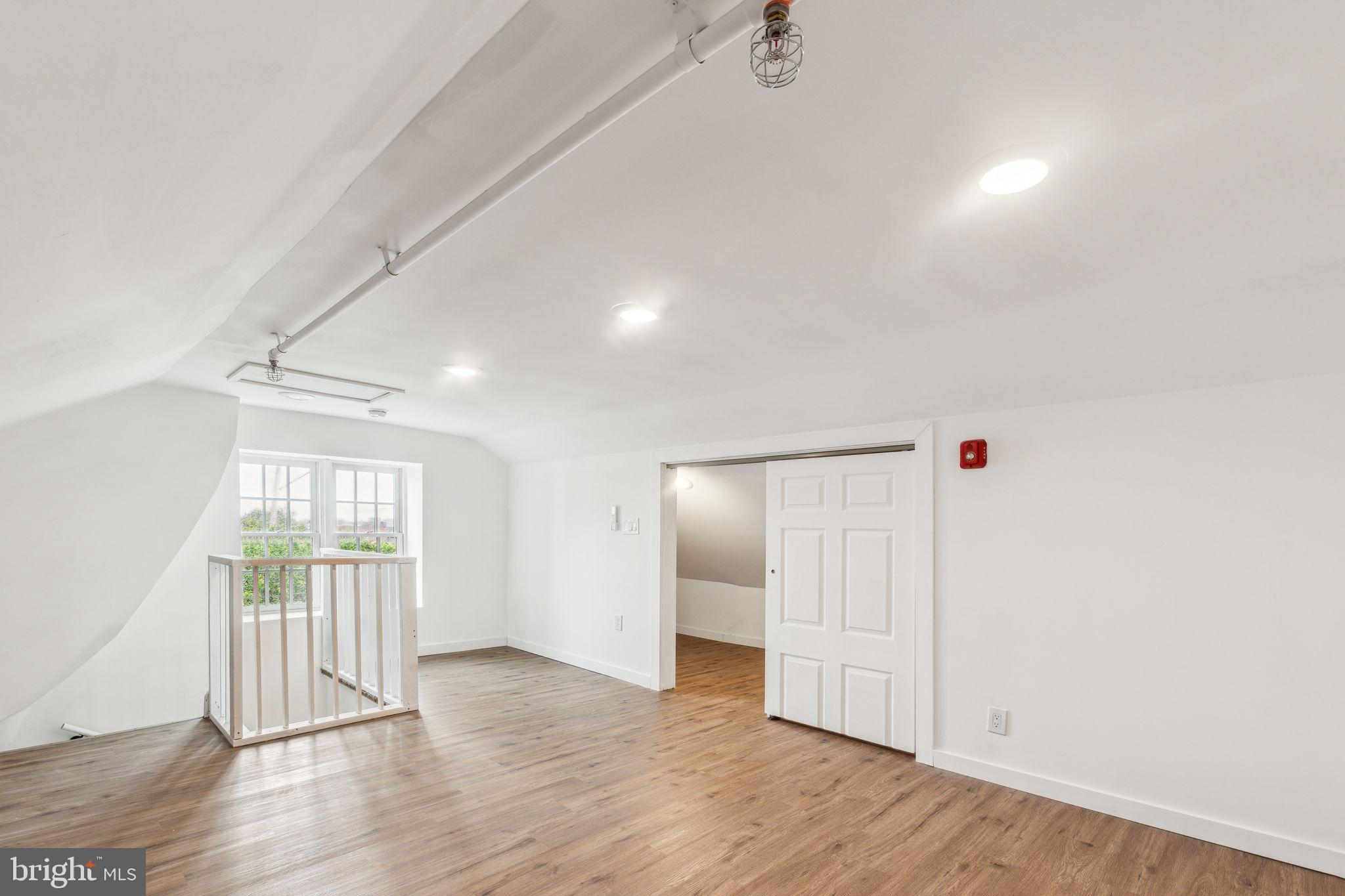 7041 Ridge Avenue Philadelphia, PA 19128 - Photo 10 of 22 an empty room with wooden floor and windows