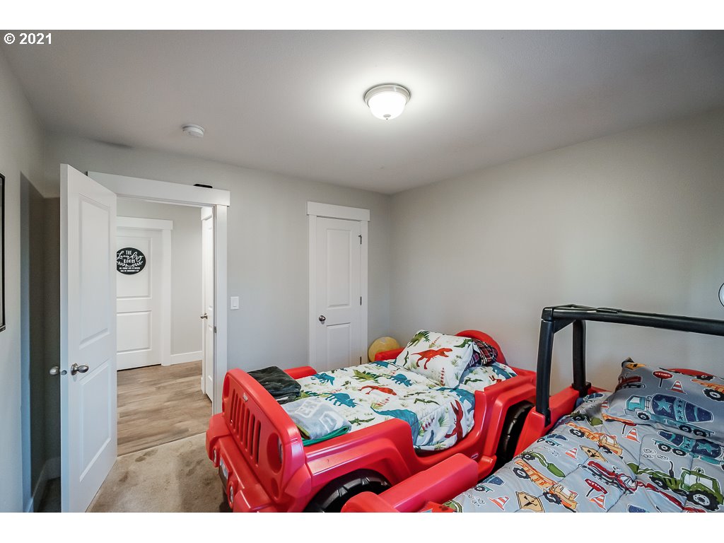 806 Wassom Street Lebanon, OR 97355 - Photo 25 of 30 a bedroom with a bed and a dresser