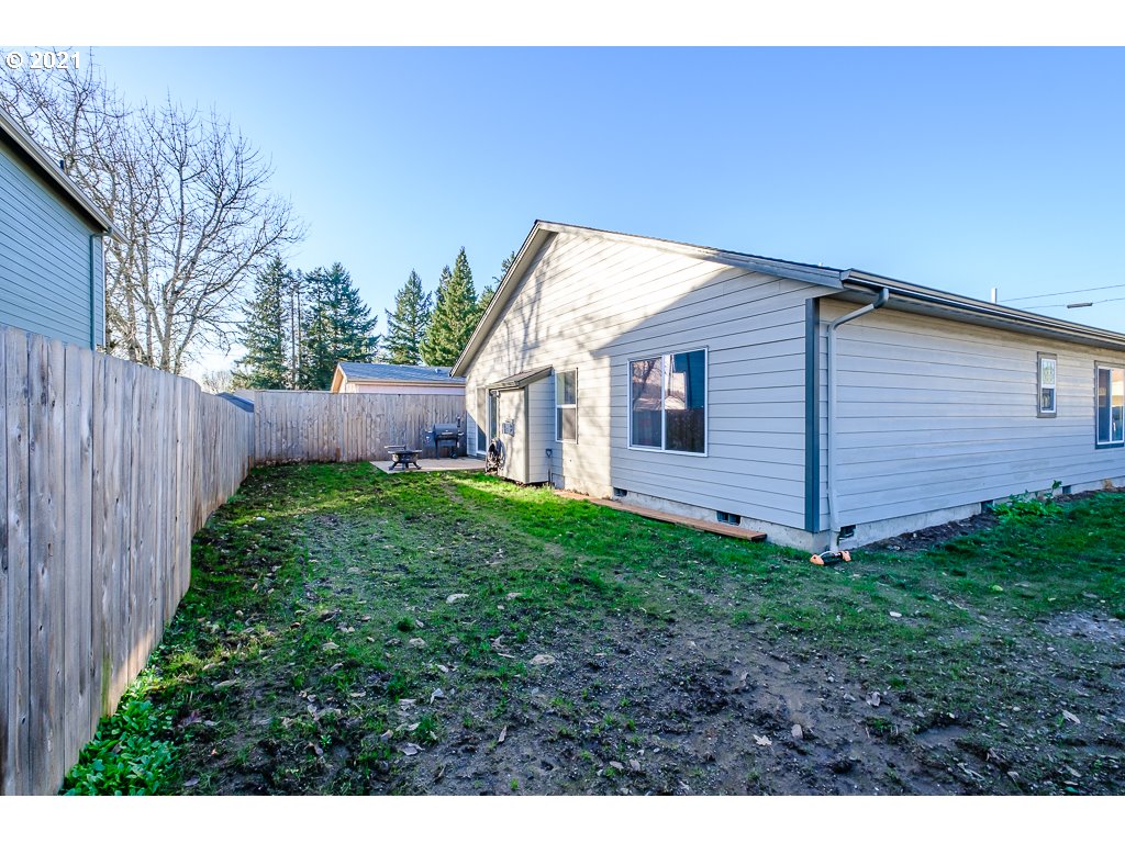 806 Wassom Street Lebanon, OR 97355 - Photo 28 of 30 a view of a backyard with wooden fence