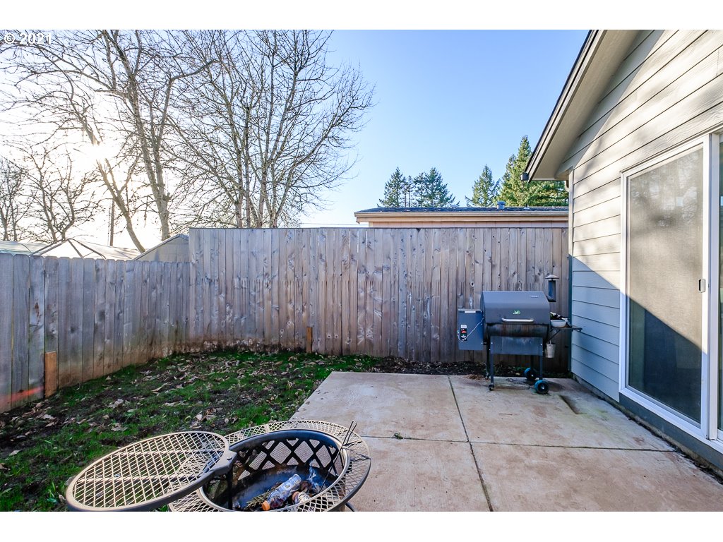 806 Wassom Street Lebanon, OR 97355 - Photo 30 of 30 a view of backyard with a tub and wooden fence