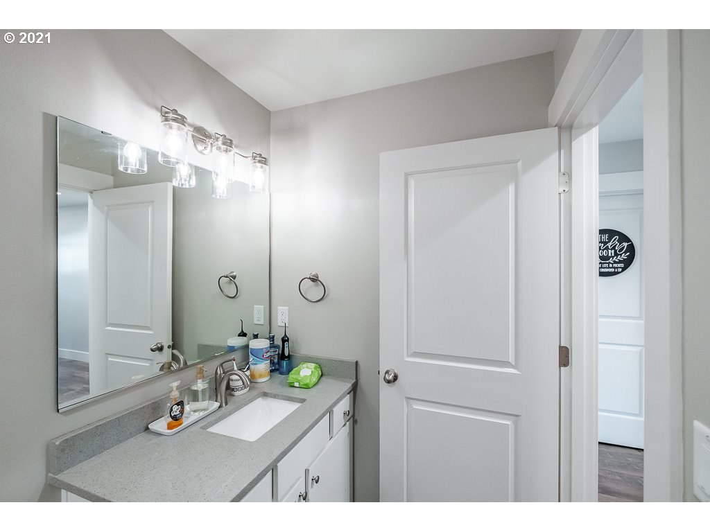 806 Wassom Street Lebanon, OR 97355 - Photo 6 of 30 a bathroom with a granite countertop sink mirror and shower